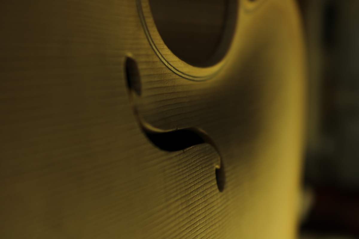 Soundhole of a new violin in raking light